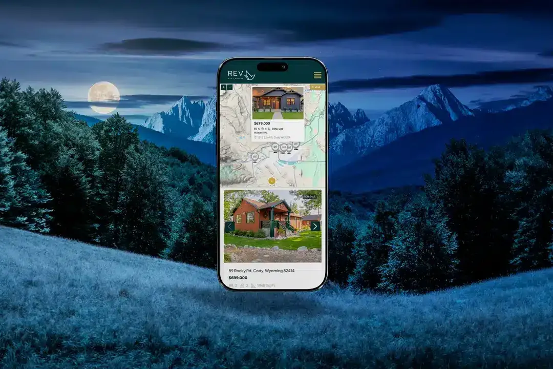 Colorado mountain town business website design on laptop with scenic mountain backdrop