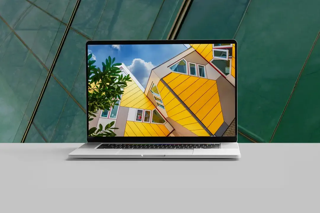 Laptop displaying a colorful architectural website design