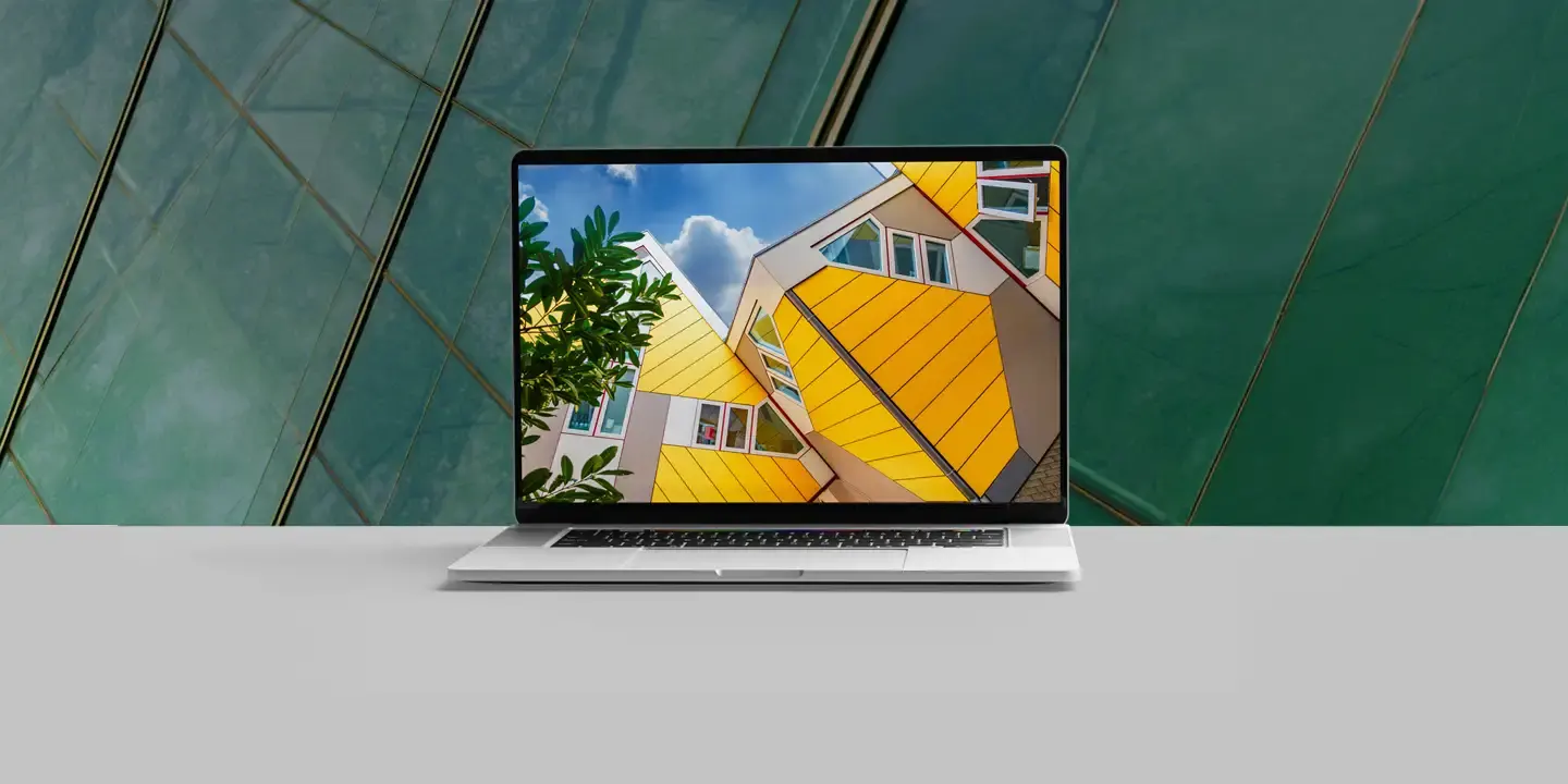 Laptop displaying a colorful architectural website design